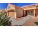 Inviting single-story home with terracotta roof, desert landscaping, a two-car garage and covered entryway at 9912 Woodhouse Dr, Las Vegas, NV 89134