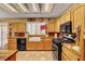 Charming kitchen with light wood cabinets, farmhouse sink, and modern appliances, perfect for culinary enthusiasts at 9912 Woodhouse Dr, Las Vegas, NV 89134