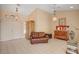 Inviting living room with tile floors, chandelier lighting, and neutral walls, perfect for comfortable living and entertaining at 9912 Woodhouse Dr, Las Vegas, NV 89134
