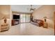 An airy living room offers neutral walls, tile floors, a vaulted ceiling, and access to the backyard at 9912 Woodhouse Dr, Las Vegas, NV 89134