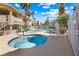 Inviting community hot tub with cool blue water surrounded by palm trees and desert landscaping at 1001 Sulphur Springs Ln # 202, Las Vegas, NV 89128