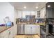Bright kitchen featuring white cabinets, stainless steel appliances, and granite countertops at 1001 Sulphur Springs Ln # 202, Las Vegas, NV 89128