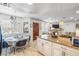 Bright, open kitchen featuring granite counters, white cabinets, and a dining area with ample natural light at 1001 Sulphur Springs Ln # 202, Las Vegas, NV 89128