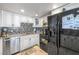 Well-equipped kitchen with white cabinets, stainless steel appliances, and a mosaic backsplash at 1001 Sulphur Springs Ln # 202, Las Vegas, NV 89128