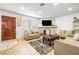 Comfortable living room with a stone fireplace, wood-look floors, and a large window for natural light at 1001 Sulphur Springs Ln # 202, Las Vegas, NV 89128
