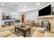 Open-concept living room leading to a dining area, featuring a stone fireplace and wood-look floors at 1001 Sulphur Springs Ln # 202, Las Vegas, NV 89128