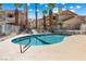 Community pool area with lounge chairs surrounded by beautiful landscaping and palm trees at 1001 Sulphur Springs Ln # 202, Las Vegas, NV 89128