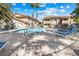 A sparkling community pool surrounded by palm trees and comfortable lounge chairs at 1001 Sulphur Springs Ln # 202, Las Vegas, NV 89128