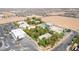 Wide aerial perspective of a property including a home, commercial building, parking, and a distant cityscape at 10445 Schirlls St, Las Vegas, NV 89141