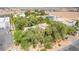 Aerial view of home surrounded by trees with a view of the city and mountains in the background at 10445 Schirlls St, Las Vegas, NV 89141