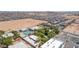 Wide aerial shot of the home and community featuring amenities like the pool, the tennis court, and the surrounding neighborhood at 10445 Schirlls St, Las Vegas, NV 89141