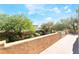 Expansive balcony featuring beautiful landscaping and a stucco privacy wall at 10445 Schirlls St, Las Vegas, NV 89141