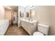 A bathroom featuring a double vanity with white cabinets and a large mirror at 10445 Schirlls St, Las Vegas, NV 89141