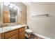 Neutral bathroom with a granite countertop and updated fixtures, plus a matching toilet and towel rack at 10445 Schirlls St, Las Vegas, NV 89141