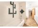 A bathroom with a tiled shower/tub combination and mosaic tiled decoration on the wall at 10445 Schirlls St, Las Vegas, NV 89141