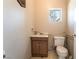 A cozy bathroom with a single sink vanity and a standard toilet at 10445 Schirlls St, Las Vegas, NV 89141