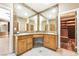 Bathroom with a double sink vanity, large mirrors, and access to a walk-in closet at 10445 Schirlls St, Las Vegas, NV 89141