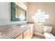 Bathroom features a mosaic mirror, granite countertops, and a tile backsplash at 10445 Schirlls St, Las Vegas, NV 89141