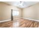 Bedroom featuring hardwood floors, a window, a ceiling fan, and neutral walls at 10445 Schirlls St, Las Vegas, NV 89141