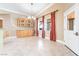 Open dining area with wooden cabinetry, chandelier, and views to the outside patio at 10445 Schirlls St, Las Vegas, NV 89141