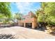 Rear view of a home featuring a three-car garage, staircase, and rooftop terrace at 10445 Schirlls St, Las Vegas, NV 89141