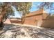 Rear exterior and parking area featuring multiple vehicle parking and shade covers at 10445 Schirlls St, Las Vegas, NV 89141