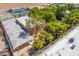 Unique aerial view of a property with a covered area with open parking, surrounded by greenery and additional amenities at 10445 Schirlls St, Las Vegas, NV 89141