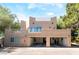Unique exterior featuring a spacious three-car garage and rooftop deck for outdoor enjoyment at 10445 Schirlls St, Las Vegas, NV 89141