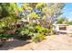 A beautifully landscaped home with mature trees and lush greenery at 10445 Schirlls St, Las Vegas, NV 89141