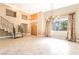 Grand foyer with high ceilings, elegant chandelier, and large windows, creating a bright and airy space at 10445 Schirlls St, Las Vegas, NV 89141