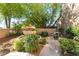 Beautifully landscaped front yard with a charming water fountain, enhancing curb appeal at 10445 Schirlls St, Las Vegas, NV 89141