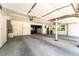 Spacious garage area with bright lighting, storage cabinets, and interior room at 10445 Schirlls St, Las Vegas, NV 89141