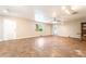 Open concept living room boasts tile flooring, ceiling fan, and neutral color palette at 10445 Schirlls St, Las Vegas, NV 89141