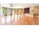 Bright living room with hardwood floors, ceiling fan, balcony access, and decorative wall accents at 10445 Schirlls St, Las Vegas, NV 89141