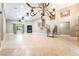 Expansive living area with a fireplace and staircase with elegant railings at 10445 Schirlls St, Las Vegas, NV 89141