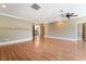 Open living room with hardwood floors, ceiling fan, and a balcony with natural light at 10445 Schirlls St, Las Vegas, NV 89141