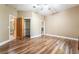 Spacious main bedroom with hardwood floors, a ceiling fan, and access to an ensuite bathroom and closet at 10445 Schirlls St, Las Vegas, NV 89141