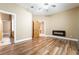 Spacious main bedroom with hardwood floors, a ceiling fan, a fireplace, and ensuite bathroom at 10445 Schirlls St, Las Vegas, NV 89141