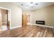 Spacious main bedroom with hardwood floors, a ceiling fan, a fireplace, and ensuite bathroom at 10445 Schirlls St, Las Vegas, NV 89141