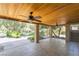 Inviting covered patio featuring tiled floors, natural wood ceilings with ceiling fans and private landscape views at 10445 Schirlls St, Las Vegas, NV 89141