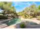 Gorgeous rock pool offering a tranquil escape surrounded by mature trees and lush landscaping at 10445 Schirlls St, Las Vegas, NV 89141