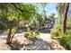 Backyard pool area surrounded by lush, mature trees and desert landscaping at 10445 Schirlls St, Las Vegas, NV 89141