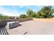 Wide rooftop featuring an AC unit, stucco privacy walls, and beautiful green tree line at 10445 Schirlls St, Las Vegas, NV 89141