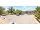 Large rooftop view with functional AC unit surrounded by stucco walls and lush mature landscape at 10445 Schirlls St, Las Vegas, NV 89141