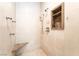Bathroom shower with dual shower heads, marble accents, and a built-in niche at 10445 Schirlls St, Las Vegas, NV 89141