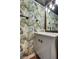 Stylish powder room featuring unique wallpaper, modern fixtures, and elegant design at 1048 Menands Ave, Las Vegas, NV 89123