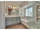 Modern bathroom with dual vanity, walk-in shower, and a separate soaking tub for relaxation at 1048 Menands Ave, Las Vegas, NV 89123