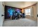 Spacious room with plush carpet and a colorful accent wall, perfect for a home office or entertainment area at 1048 Menands Ave, Las Vegas, NV 89123