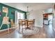 Inviting dining area with a round wooden table and chairs, showcasing stylish decor and natural light at 1048 Menands Ave, Las Vegas, NV 89123