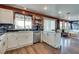 Bright kitchen with white cabinets, stainless steel appliances, and an open layout connecting to the living area at 1048 Menands Ave, Las Vegas, NV 89123